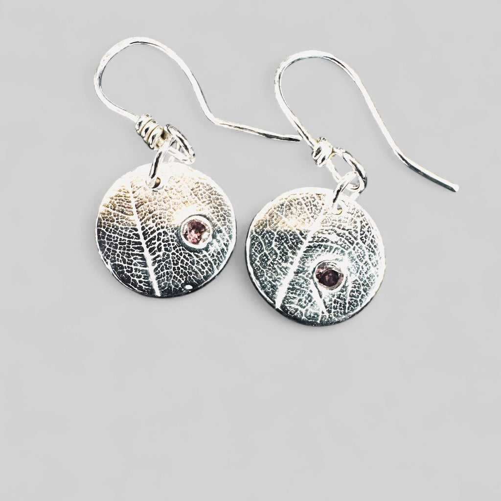 Artisan Hancrafted sustainable Bespoke Fine Silver disc leaf textured earrings with cubic Zirconia red gemstone valentines birthday anniversary gift only one pair available.