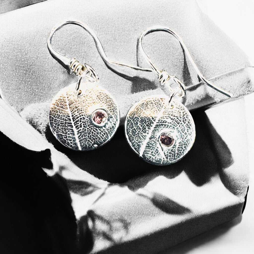 Artisan Hancrafted sustainable Bespoke Fine Silver disc leaf textured earrings with cubic Zirconia red gemstone valentines birthday anniversary gift only one pair available.