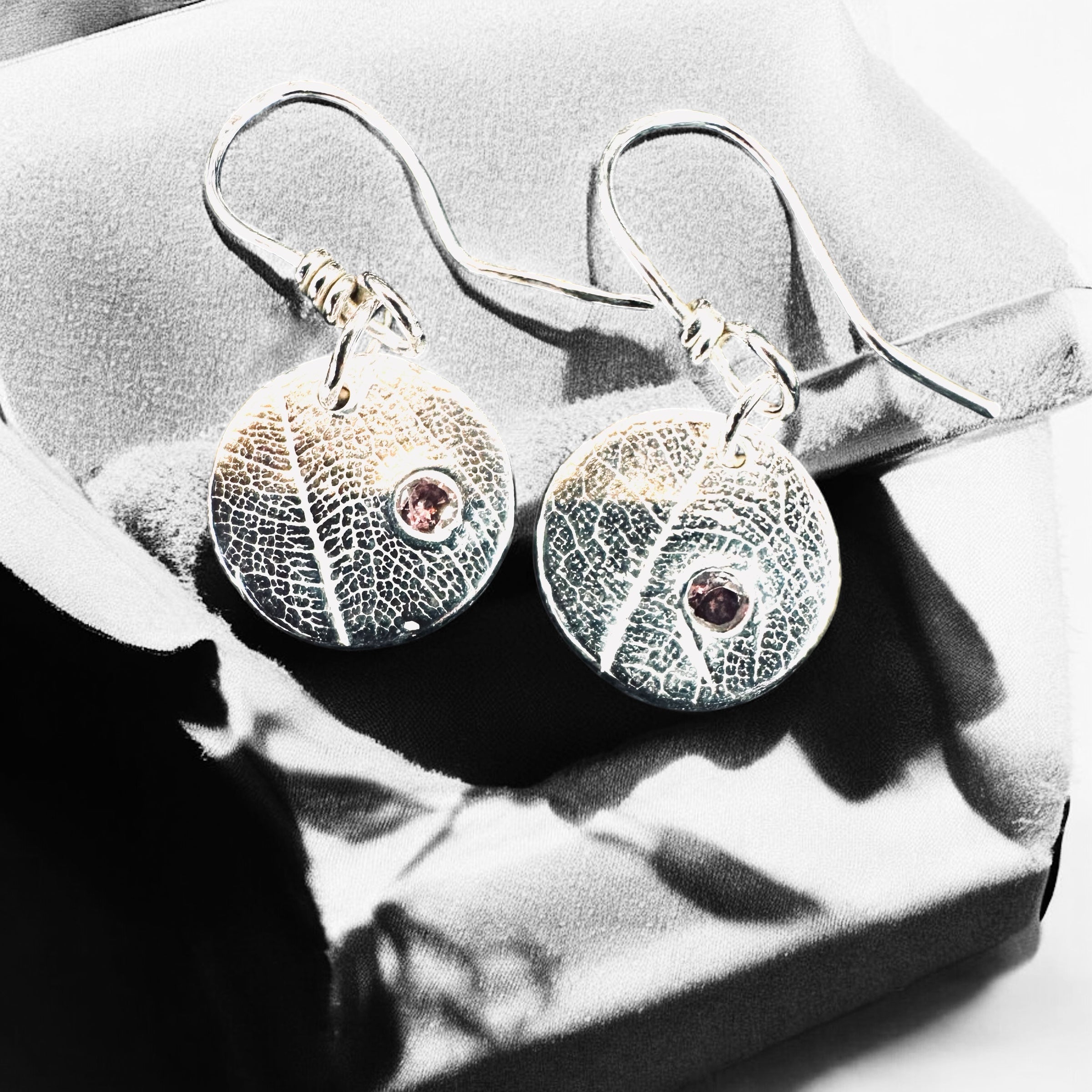 Artisan Hancrafted sustainable Bespoke Fine Silver disc leaf textured earrings with cubic Zirconia red gemstone valentines birthday anniversary gift only one pair available.