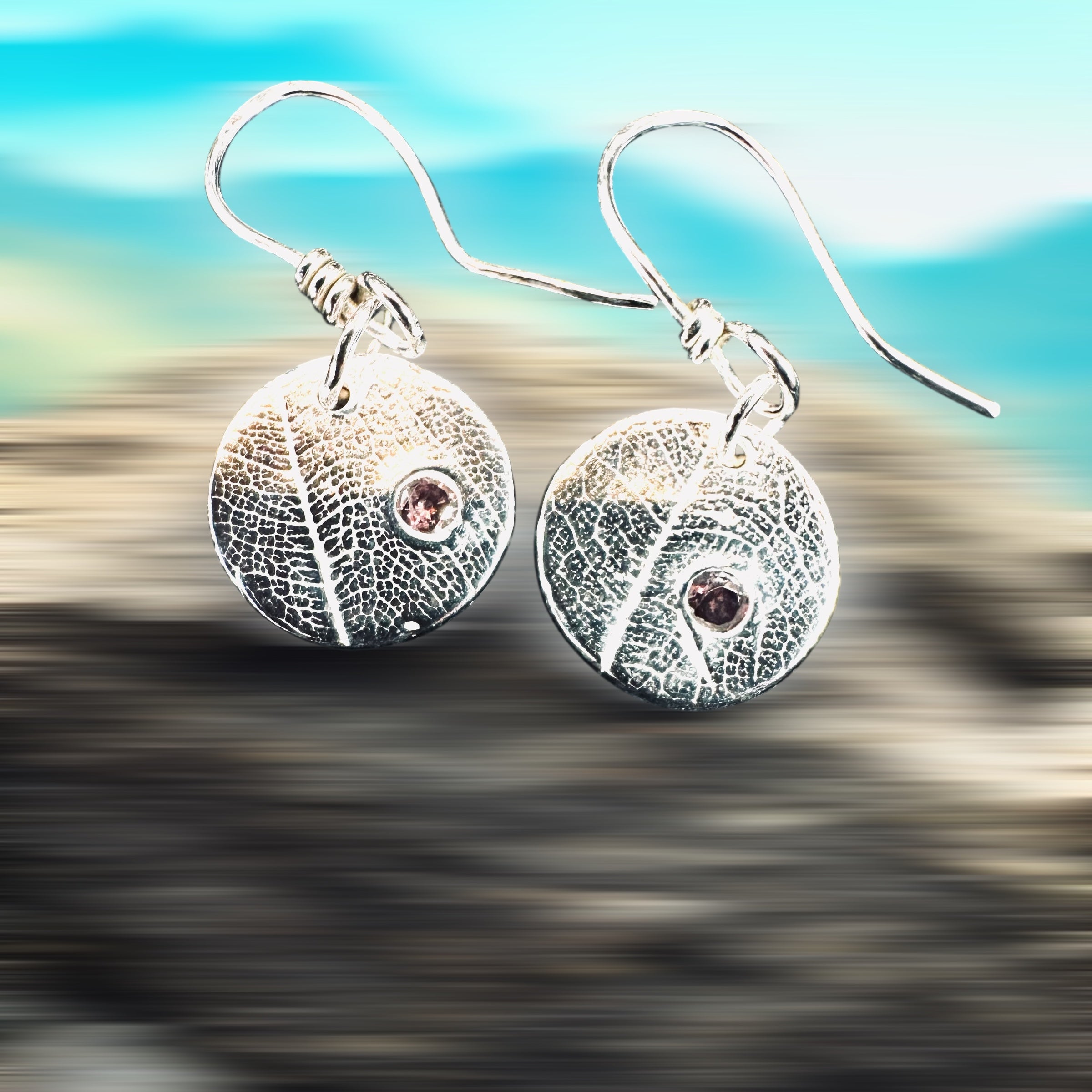 Artisan Hancrafted sustainable Bespoke Fine Silver disc leaf textured earrings with cubic Zirconia red gemstone valentines birthday anniversary gift only one pair available.